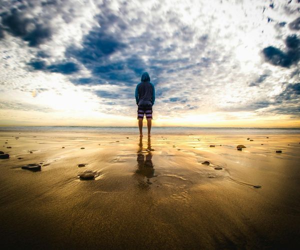 Silhouette of a person meditating during a beautiful sunset.